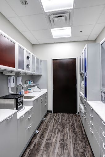 A long hallway filled with cabinets and drawers in a dental office.