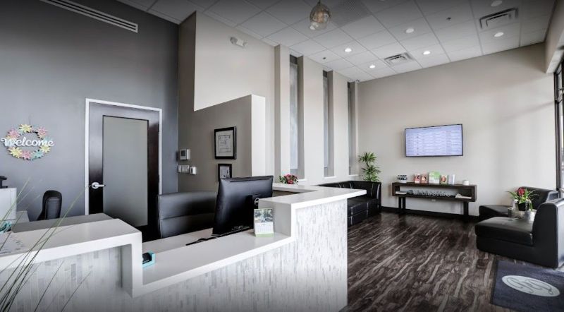 A dental office with a waiting room and a reception desk.