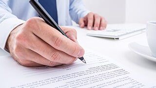 Signing a Document - Insurance Agent in Artesia, NM