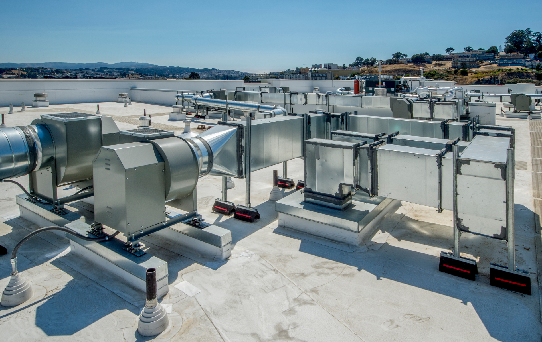 A rooftop with a lot of ventilation pipes on it
