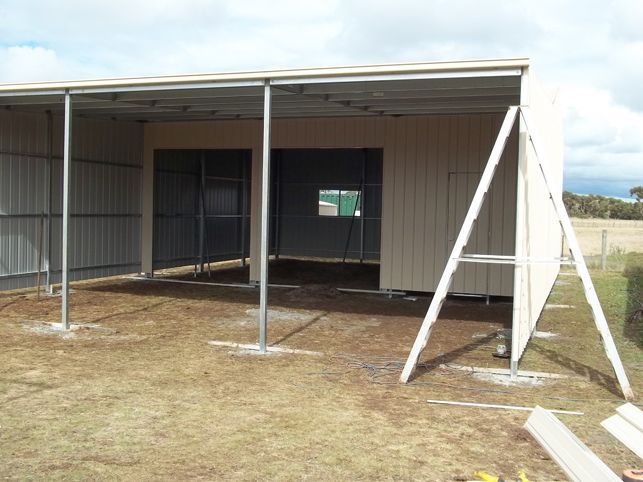 A building is being built in the middle of a field.
