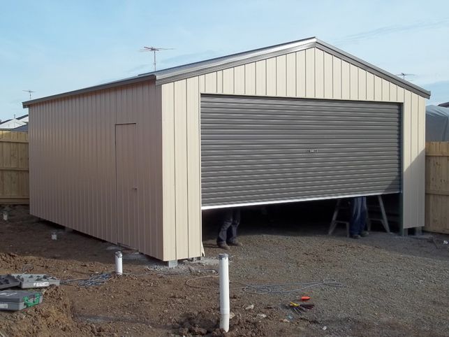 A garage with a roller door that is open