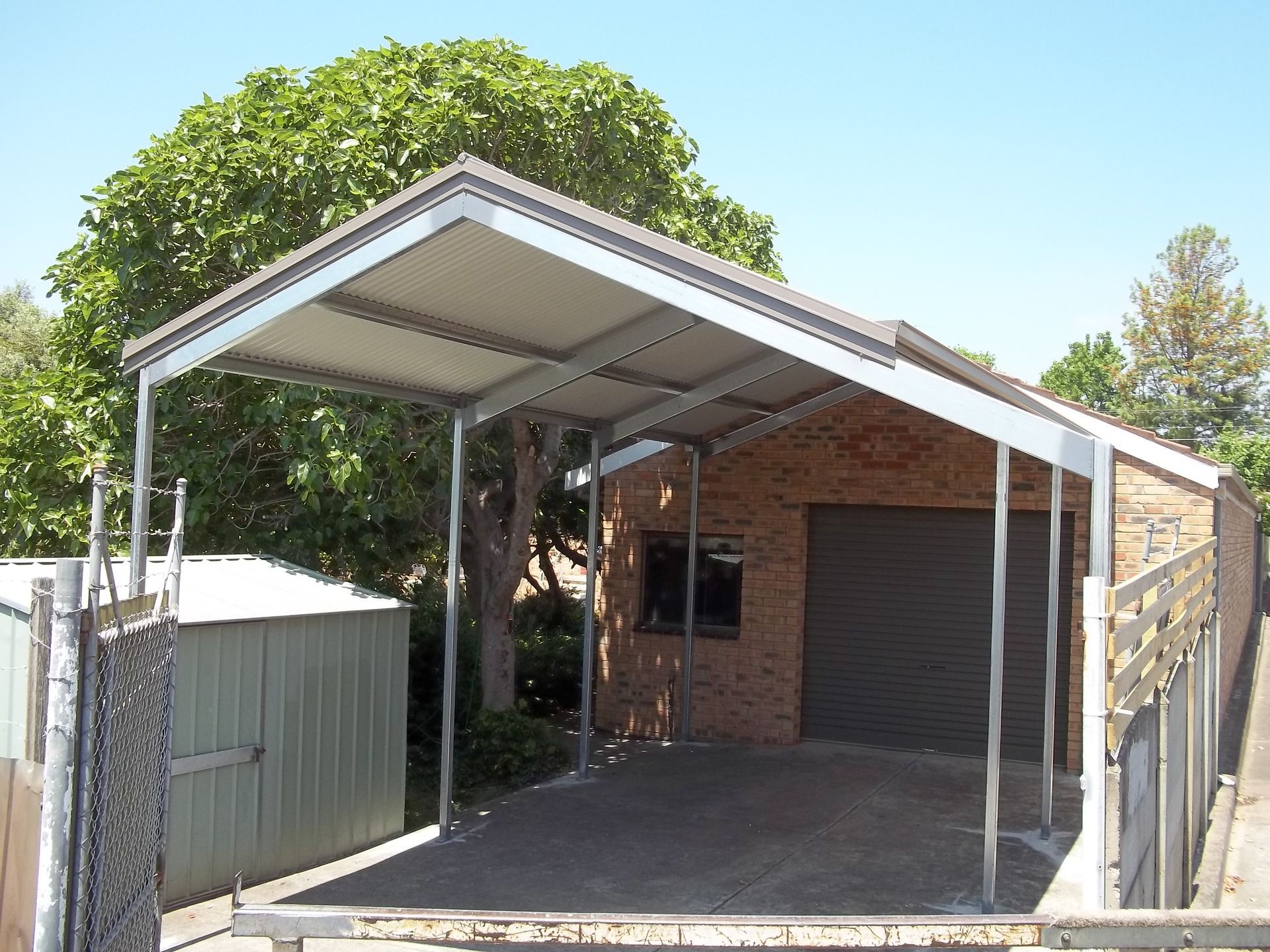 A brick building with a carport in front of it