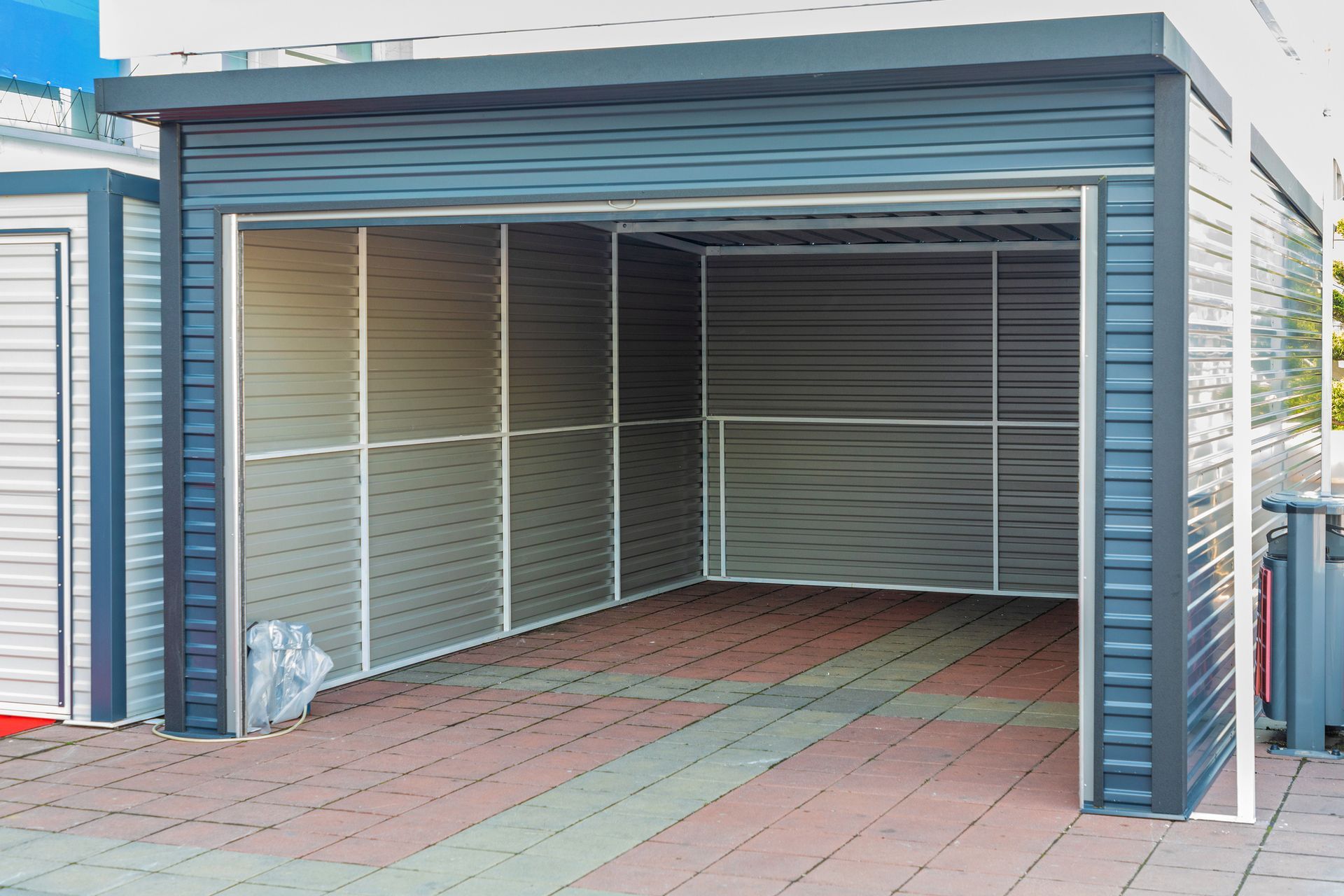 A garage with a sliding door and a brick floor