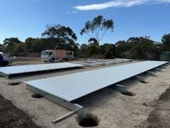 A truck is parked in the background of a construction site.