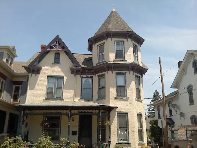 A large white house with a tower on top of it