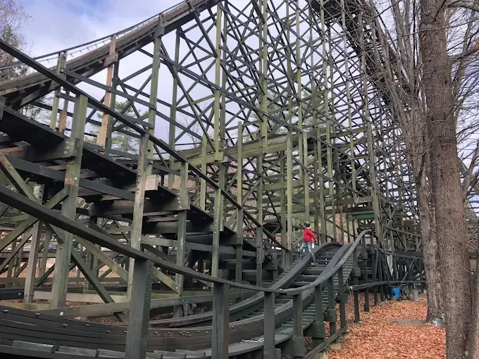 A person is standing on the side of a roller coaster.