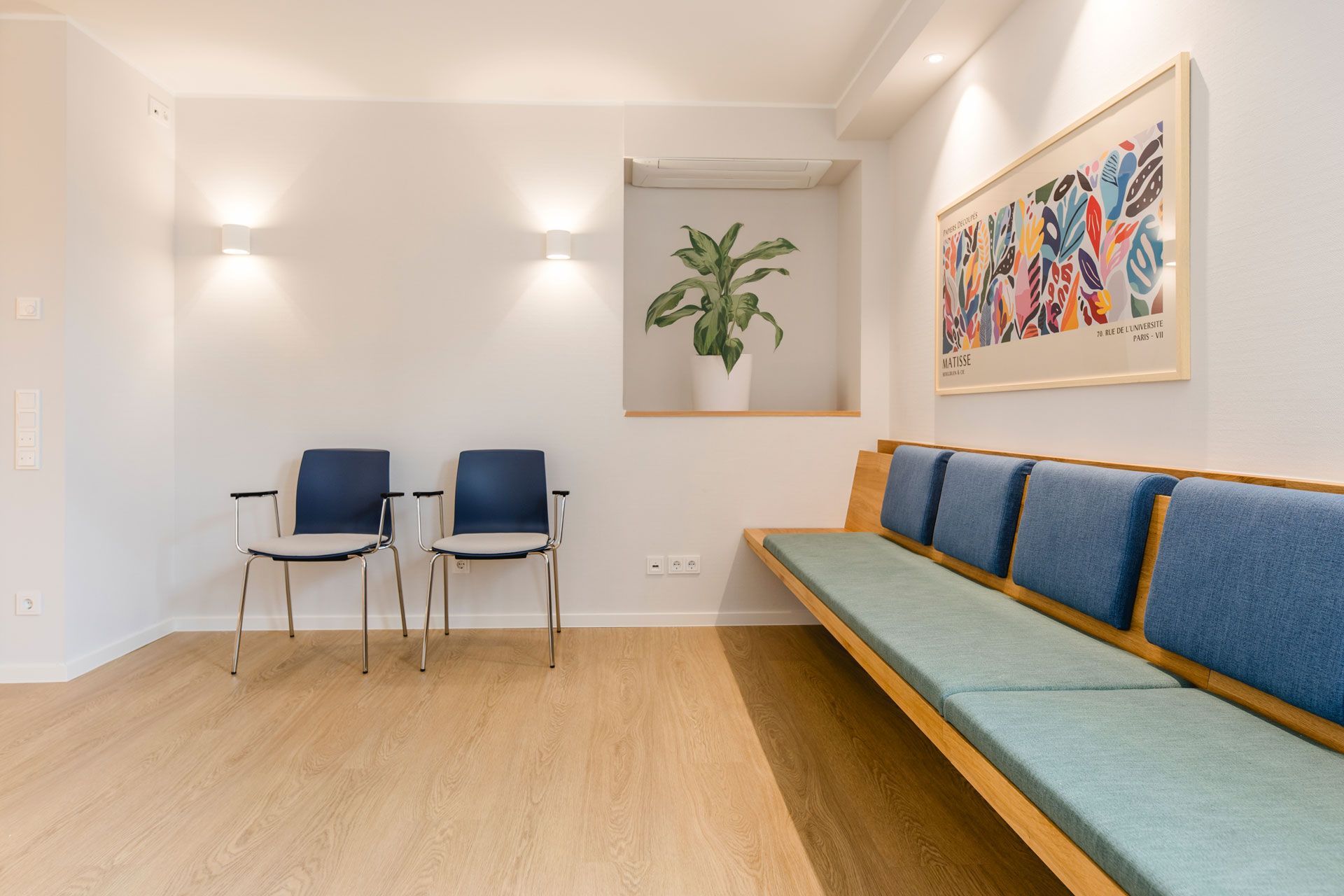 Wartezimmer mit einer langen Bank und zwei Stühlen