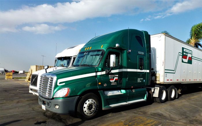 Two Semi Trucks Are Parked Next to Each Other in A Parking Lot — Saratoga Springs, UT — Younker Bros