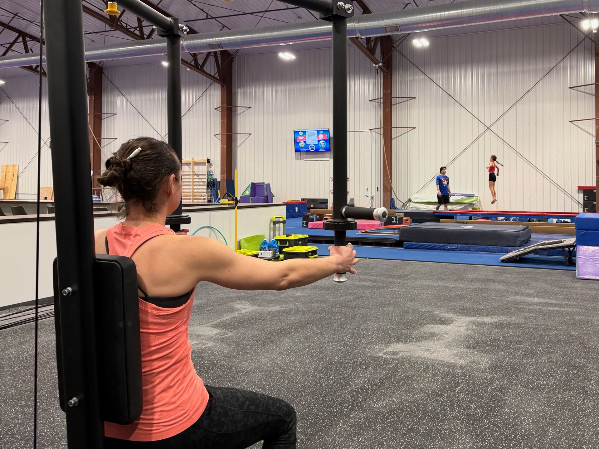 Child running through purple foam obstacle course in an indoor gym