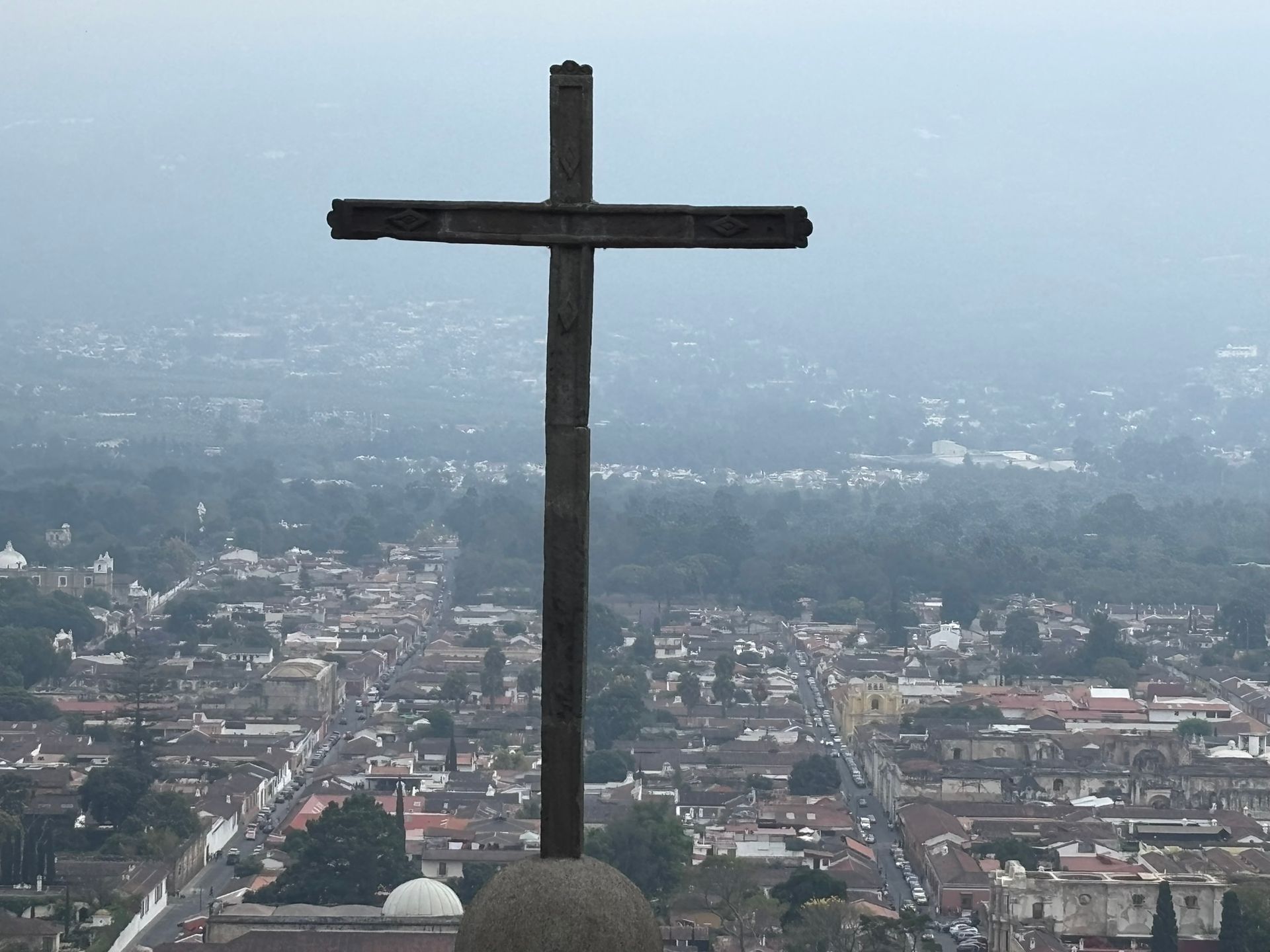 A large wooden cross in the middle of a city