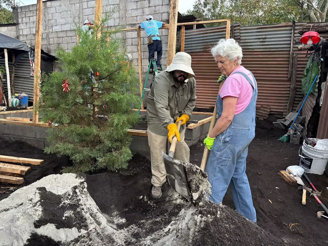 A man and a woman are digging in the dirt.