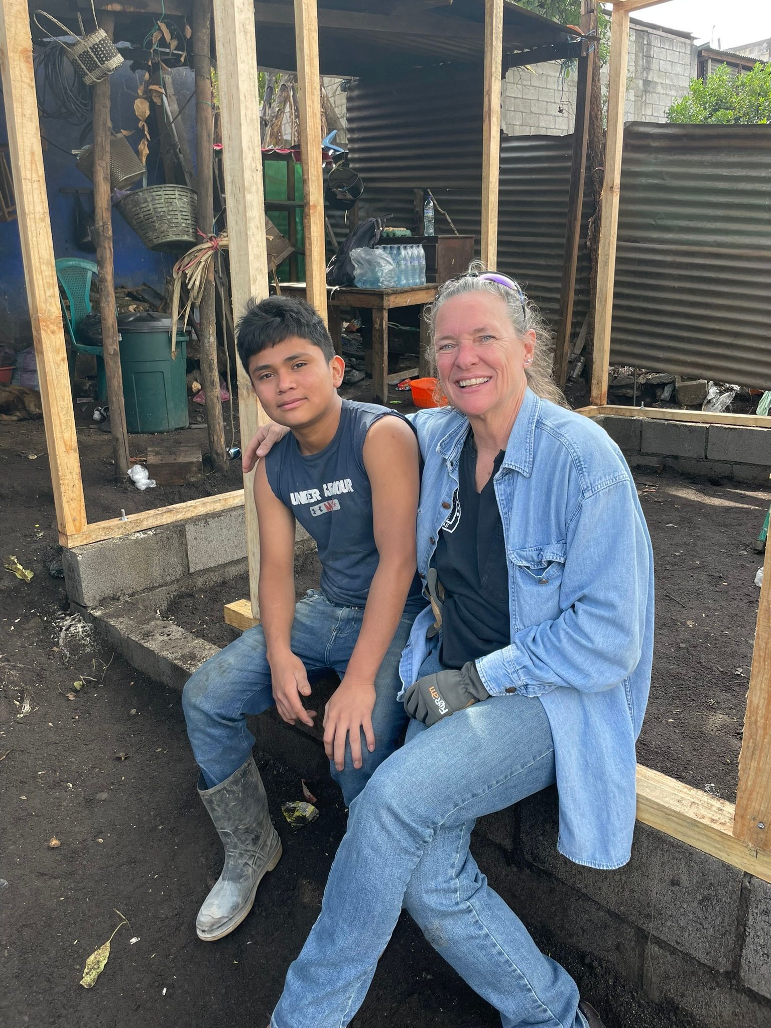 A woman and a boy are sitting next to each other.