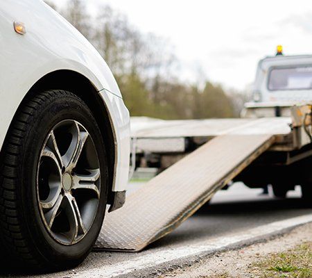 Car on a tow truck on a roadside Car on a tow truck on a roadside