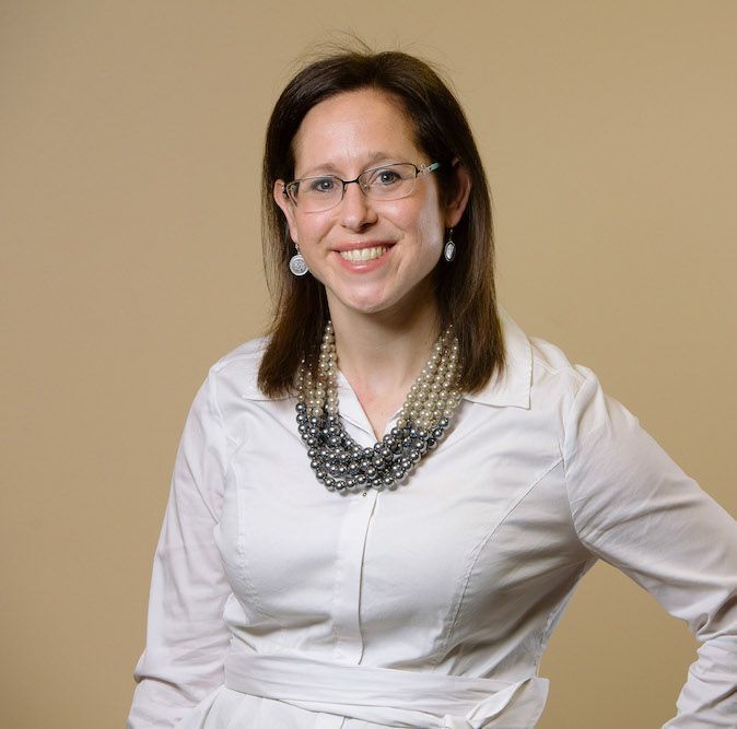 A nurse is preparing an iv for a patient in a hospital room.