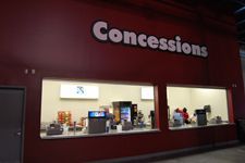 A red building with a sign that says concessions on it.