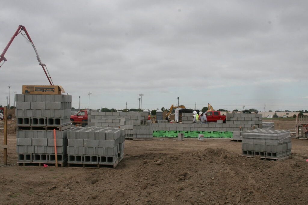 A construction site with a concrete pump in the background