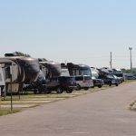 A row of rvs parked on the side of a road.