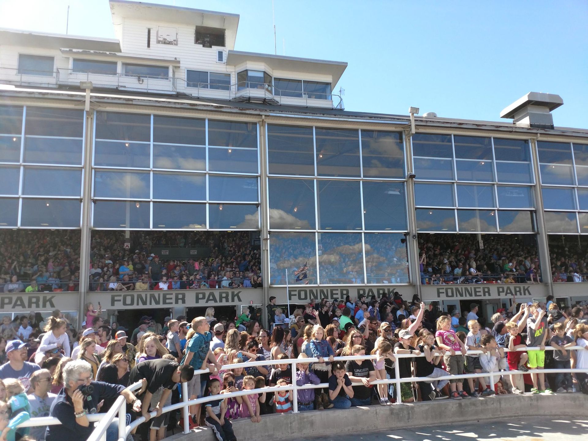 A crowd of people are watching a rodeo at fonner park