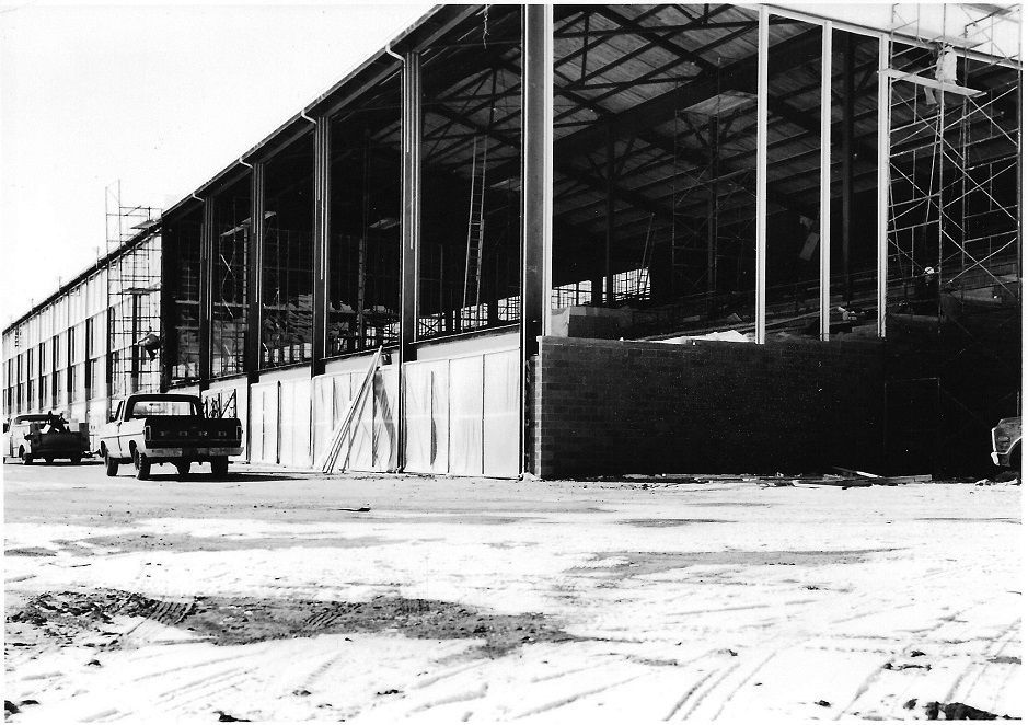 A black and white photo of a building under construction