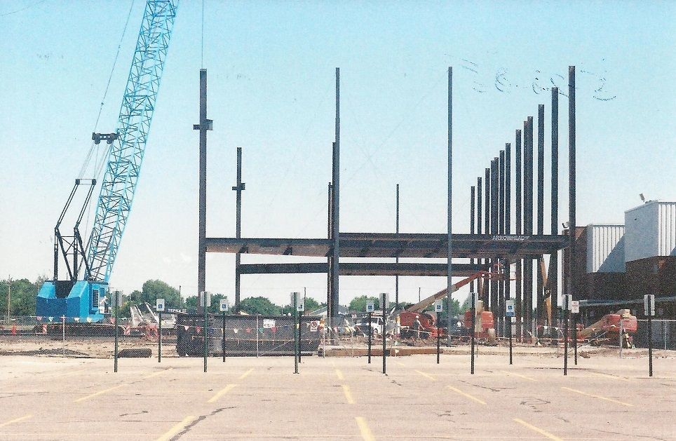 A construction site with a blue crane in the background
