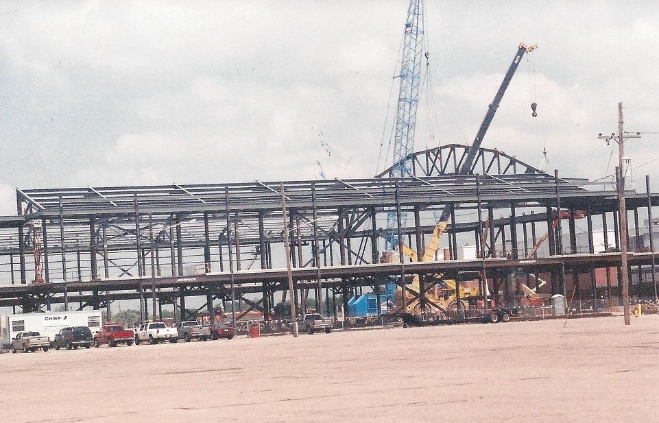 A large building under construction with a crane in the background