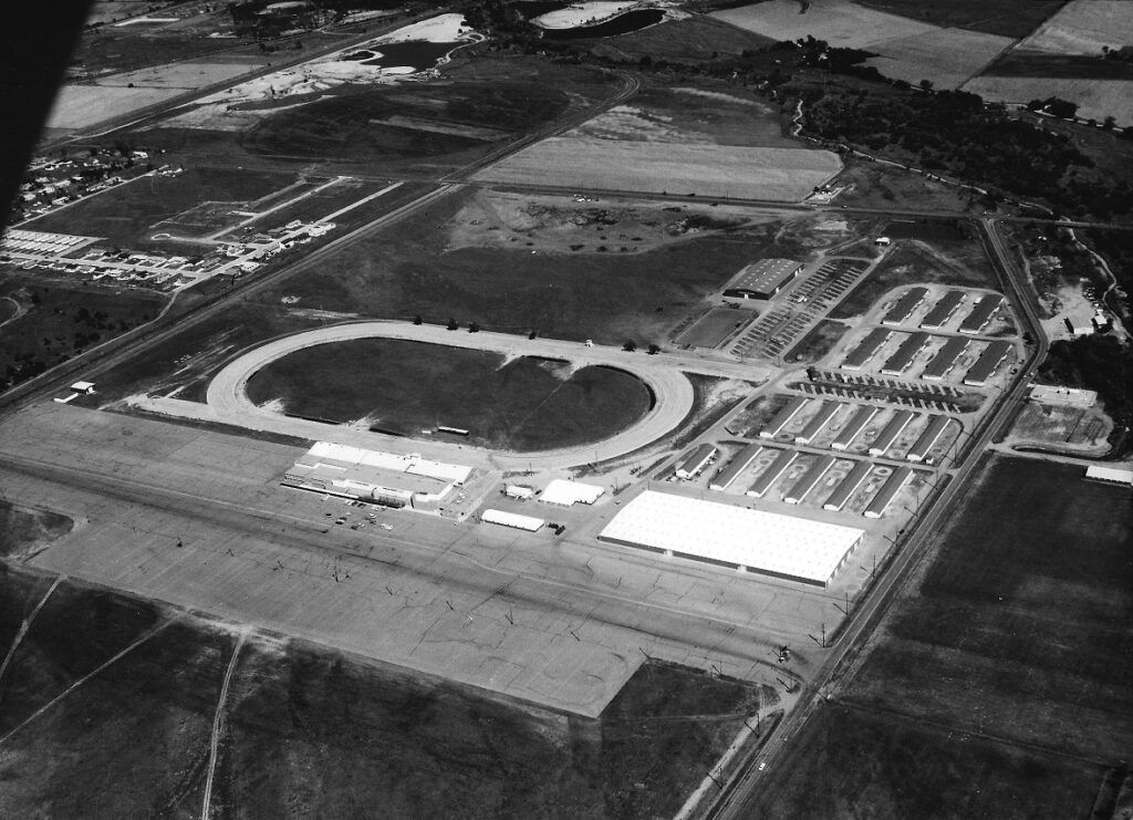 A black and white aerial view of a race track