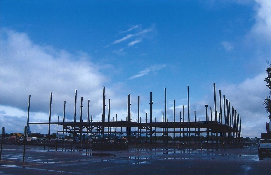 A building under construction with a blue sky in the background