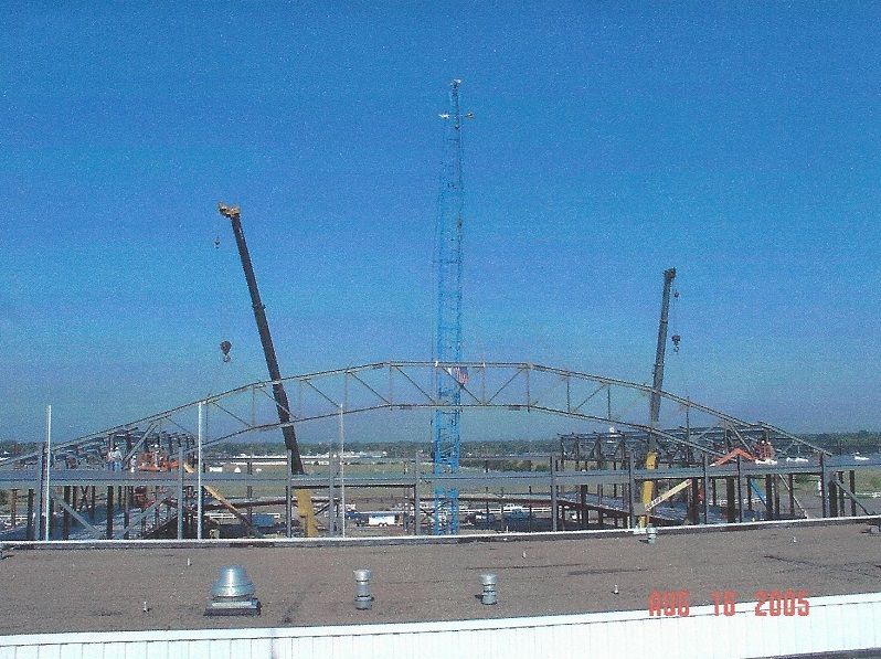 A building under construction with a blue sky in the background