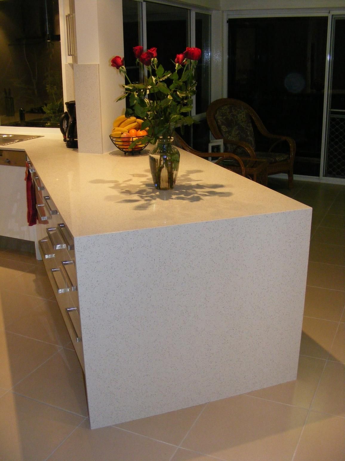 Kitchen Island With a Vase of Flowers on It — Advance Kitchens in Caloundra, QLD
