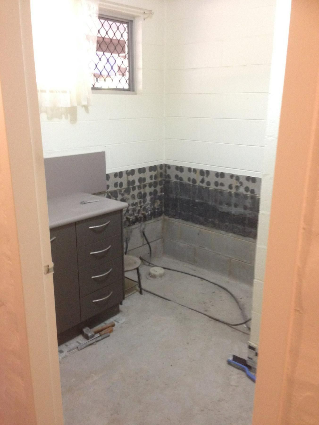 Bathroom Under Construction With a Sink and a Window — Advance Kitchens in Caloundra West, QLD