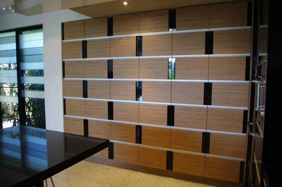 Room With a Wall of Wooden Cabinets and a Table — Advance Kitchens in Landsborough, QLD