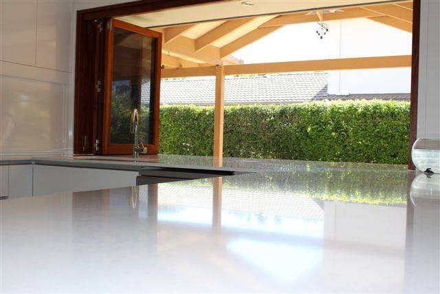 Kitchen With a Large Window and a White Counter Top — Advance Kitchens in Sunshine Coast, QLD