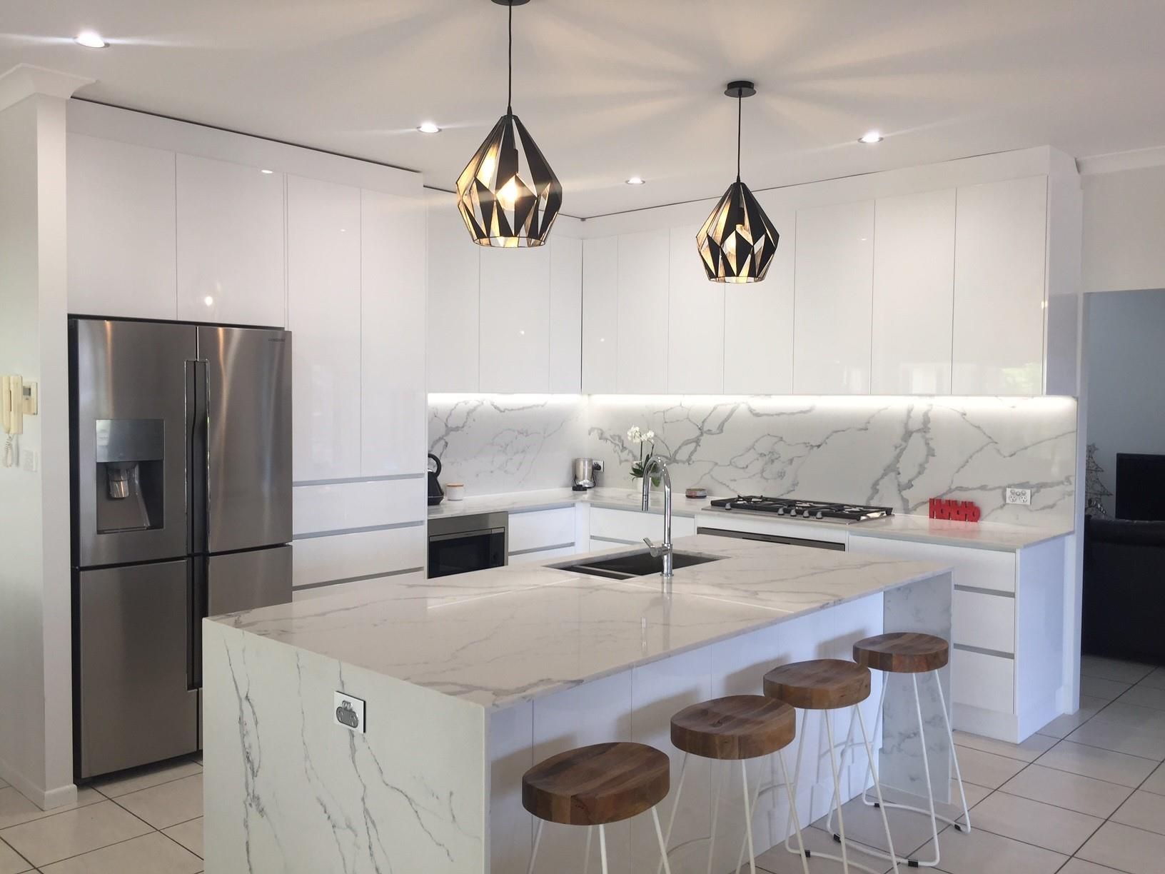 Kitchen With a Large Island and a Stainless Steel Refrigerator — Advance Kitchens in Caloundra West, QLD