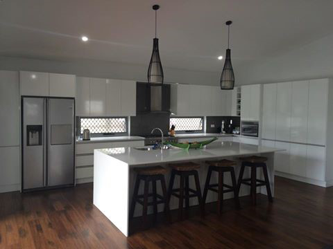 Kitchen With White Cabinets and Stools and a Large Island — Advance Kitchens in Caloundra, QLD