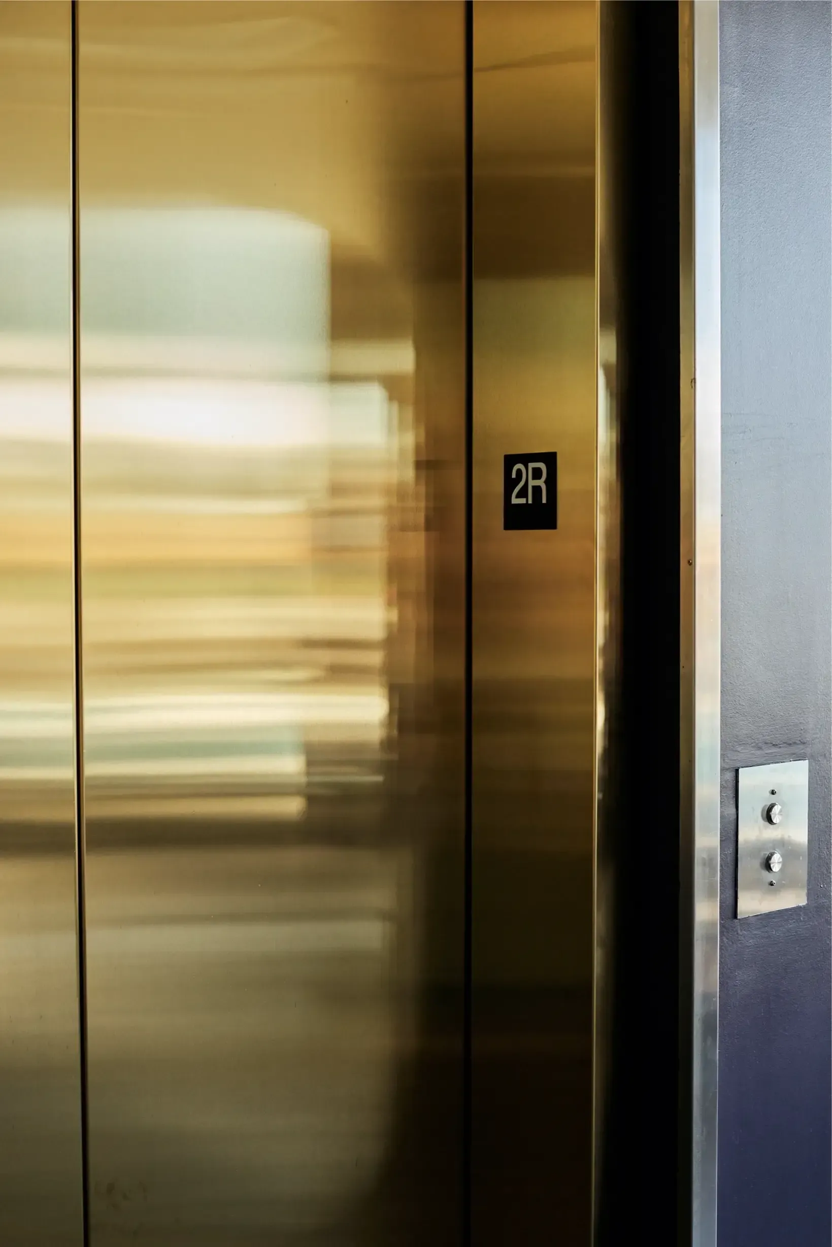 Elevator doors with a 2R floor marker in a building hallway at The Walkway, which offers Minneapolis apartments for rent.