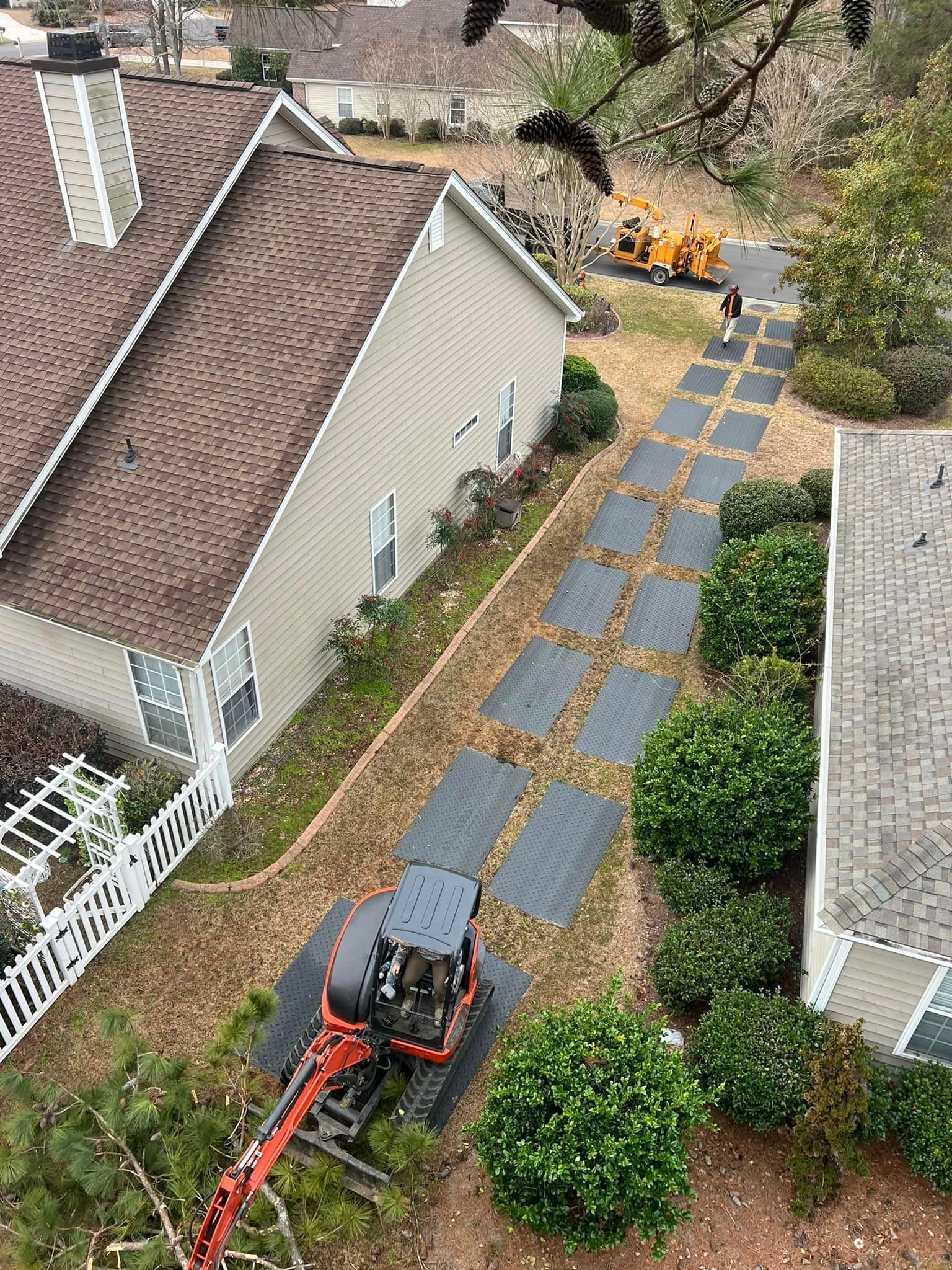 An aerial view of a house with a tractor in front of it.