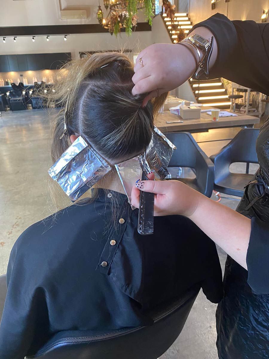 A Woman Is Getting Her Hair Dyed — Janine Wellings Hair Art In Belmont, NSW