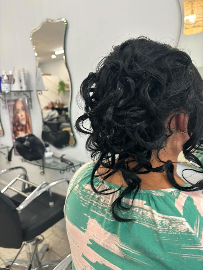 A Woman Is Sitting In A Hair Salon — Janine Wellings Hair Art In Belmont, NSW
