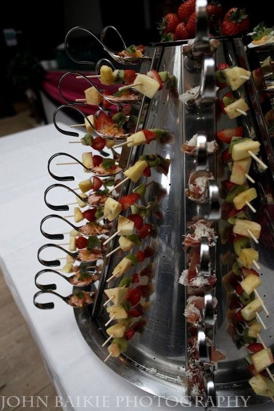 A tray of fruit skewers with the name john written on the bottom