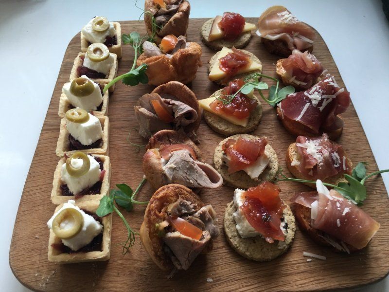 A wooden cutting board with a variety of food on it