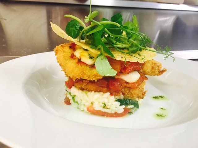 A close up of a plate of food with rice and vegetables