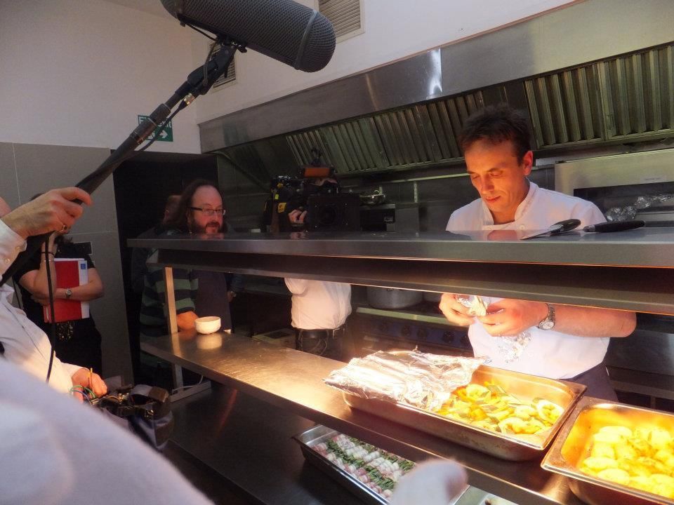 A man is holding a microphone in a kitchen