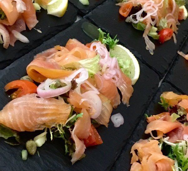 A close up of a plate of food with salmon and vegetables