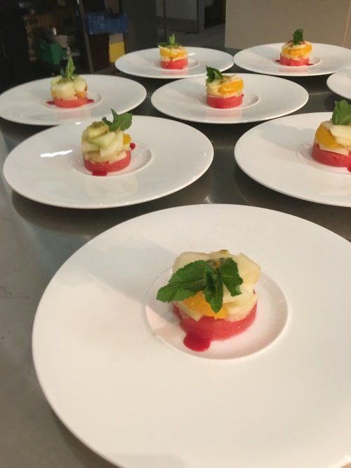 A bunch of white plates with food on them