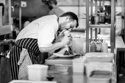 Work at out CPU Inverness, Highlands A black and white photo of a chef preparing food in a kitchen.