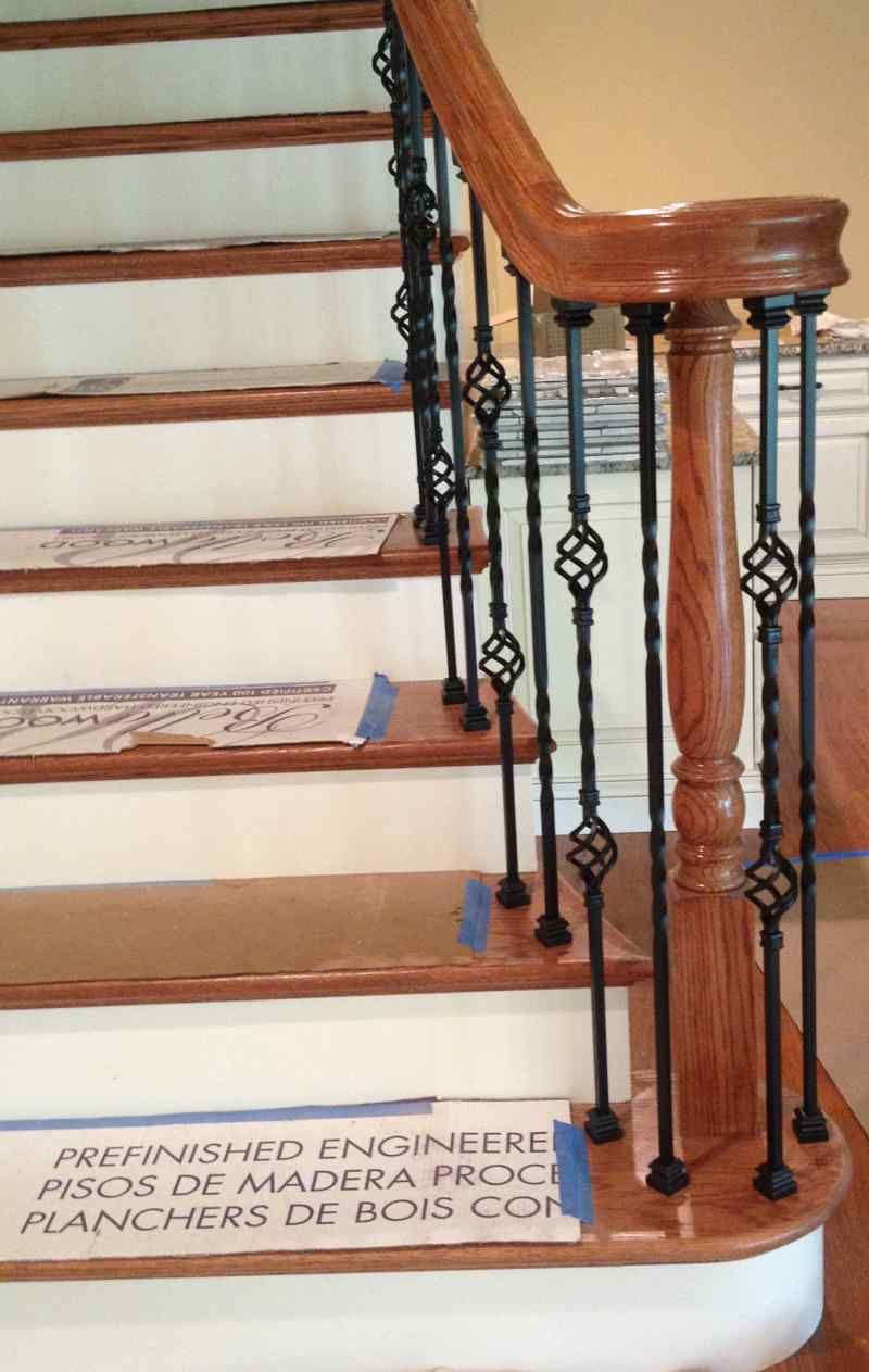 A wooden staircase with a metal railing and a sign that says responsible engineers