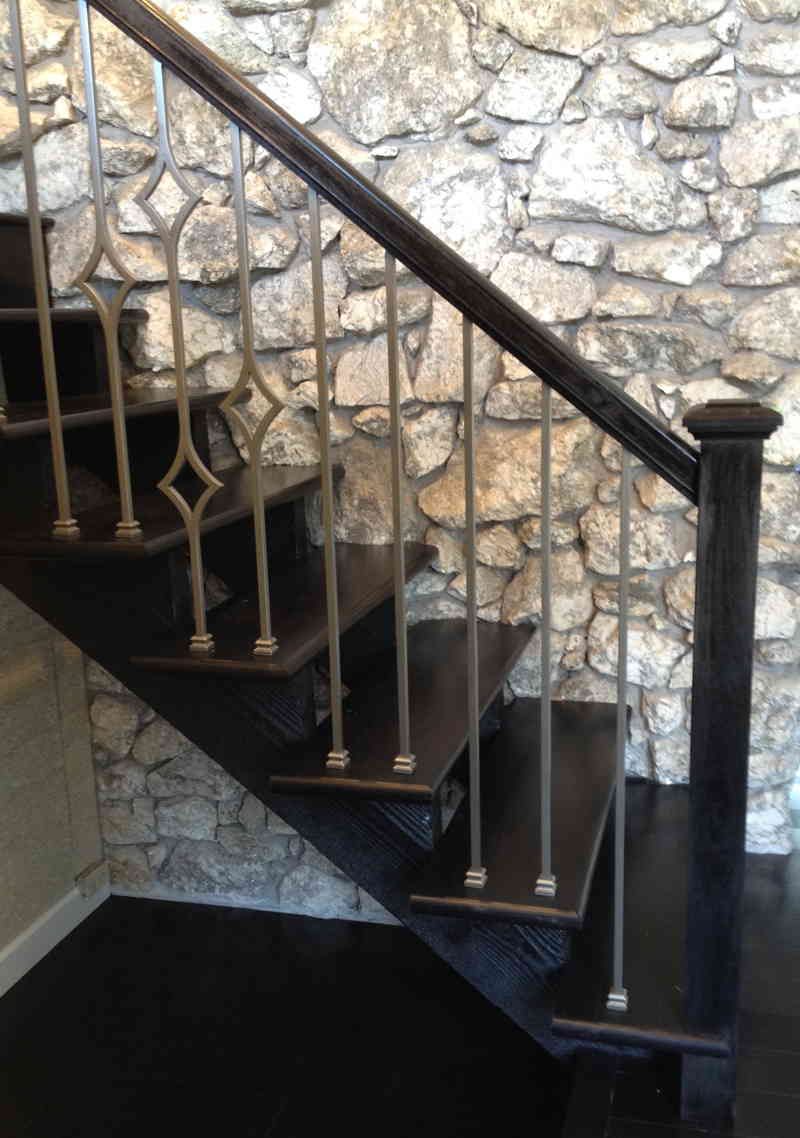 A staircase with a stone wall in the background