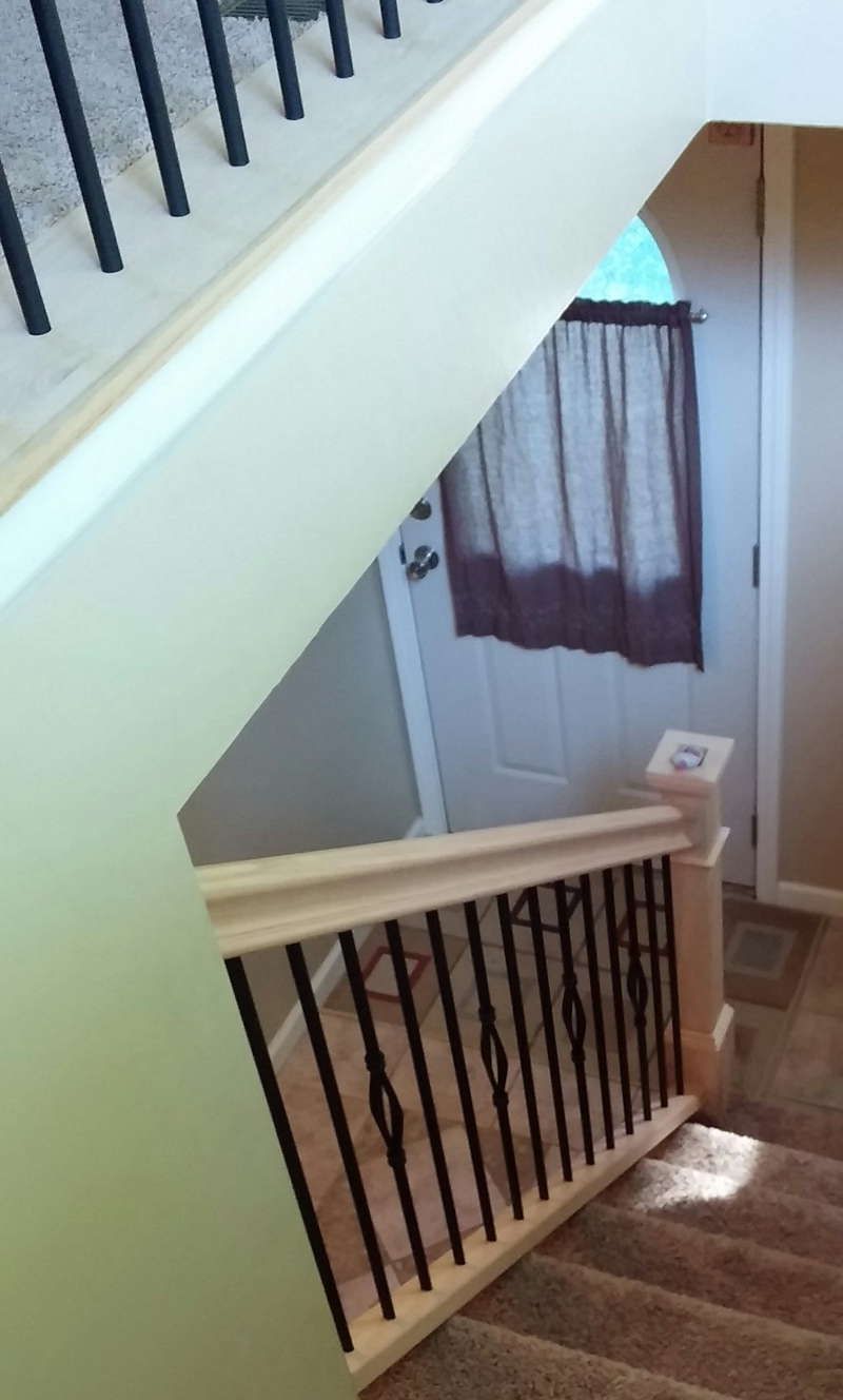 A staircase leading up to a door with a curtain hanging on it