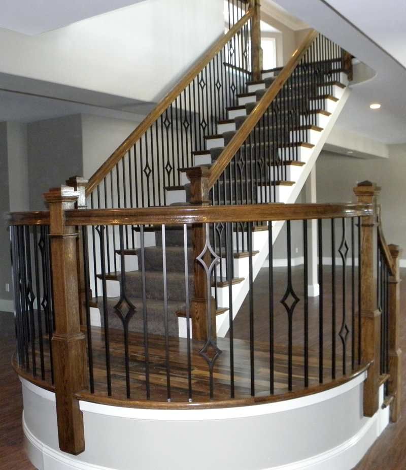 A staircase with a wooden railing and a metal railing
